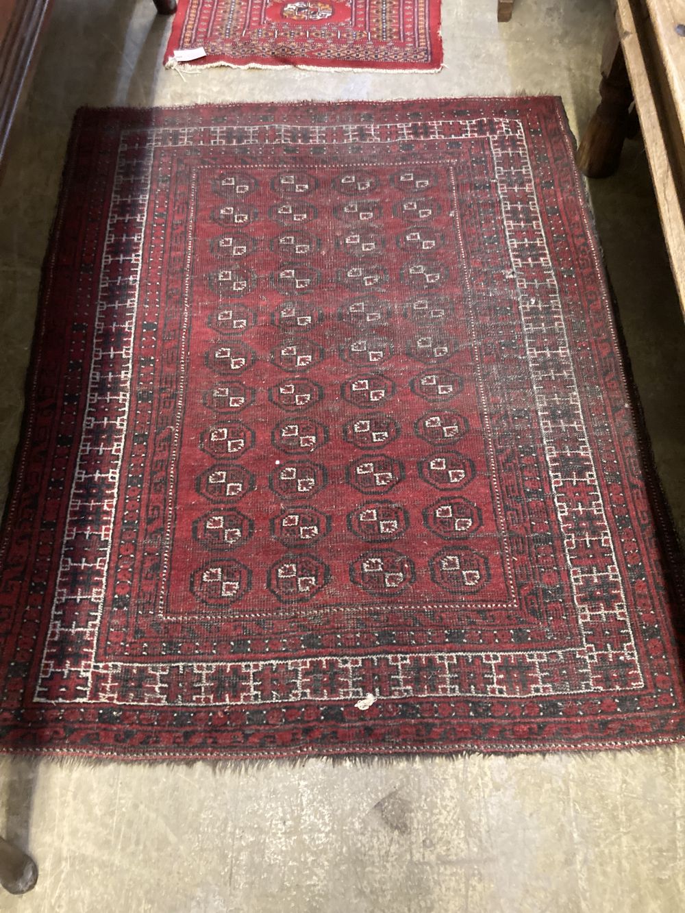 Two Afghan red ground rugs, largest 140 x 110cm